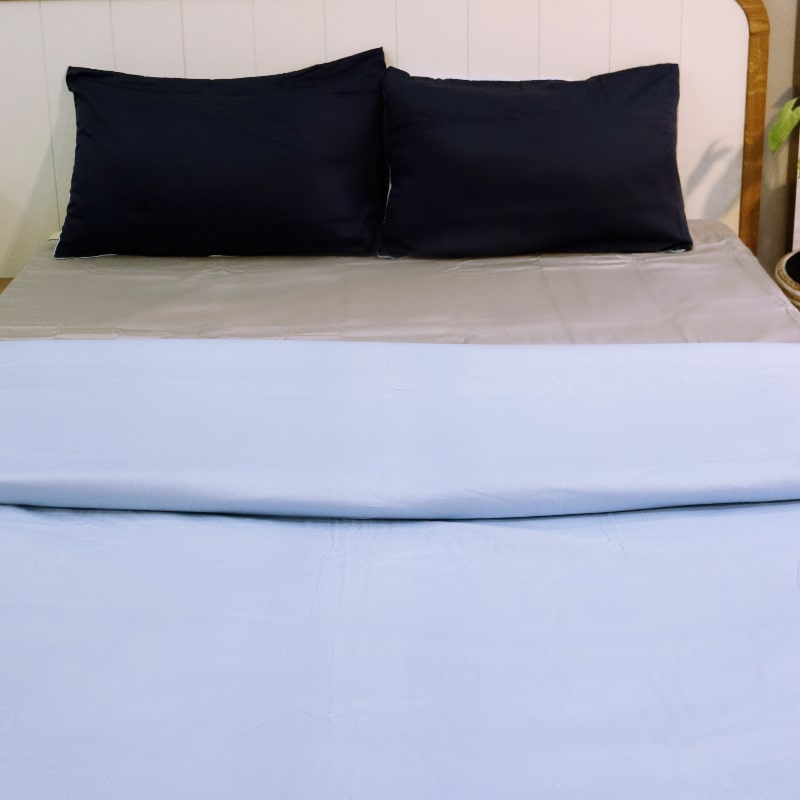 Both navy blue pillow covers and sky blue duvet cover side of the Navy Blue-Sky Blue Reversible Egyptian Cotton Duvet Cover, a dual king size duvet cover you can buy online at Sukham Home, a sustainable furniture, gardening and home decor store in Kolkata, India