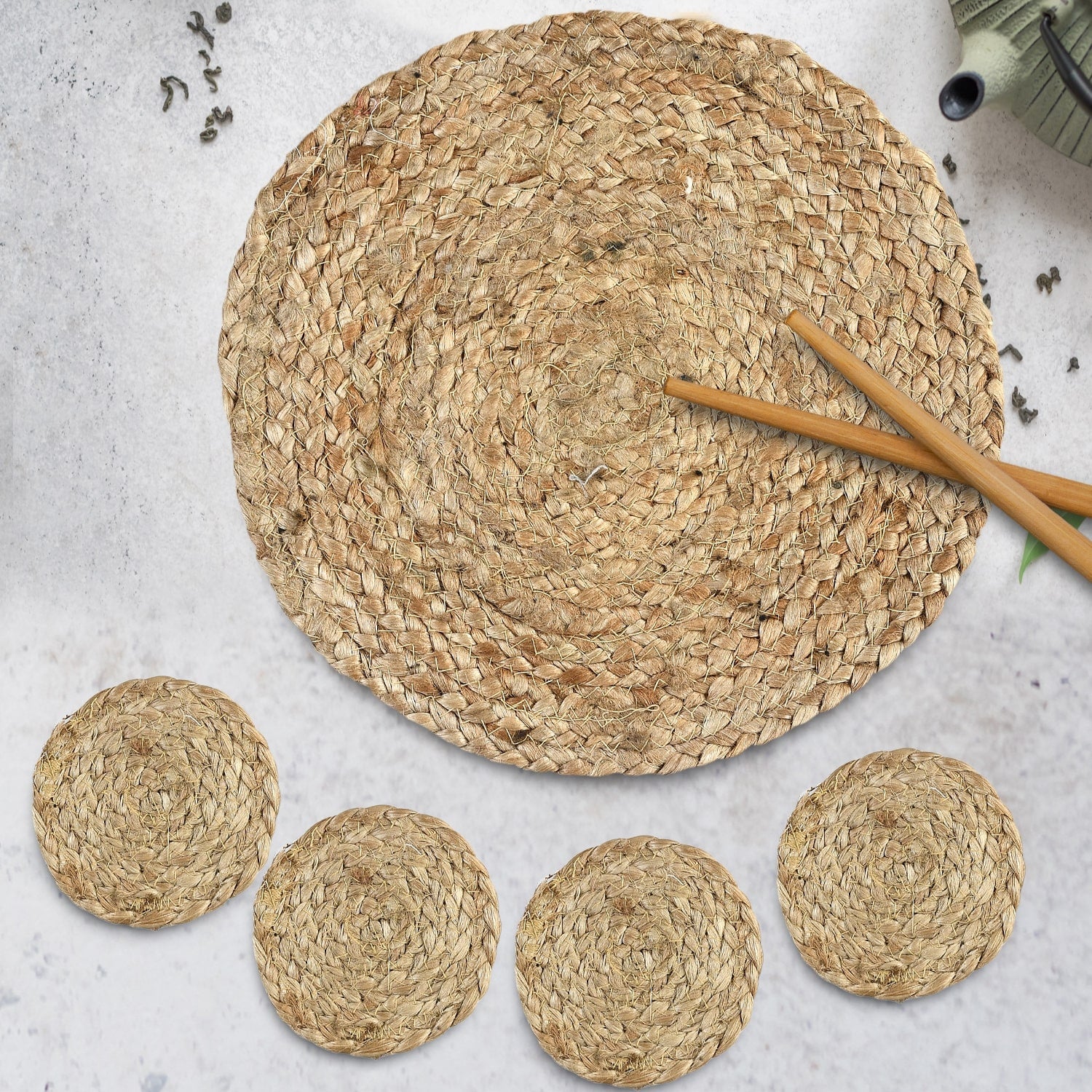 Placed on a table, the Jute Placemat & Coaster set, a set of 6 round table mats and coasters you can buy online at Sukham Home, a sustainable furniture, kitchen & dining and home decor store in Kolkata, India