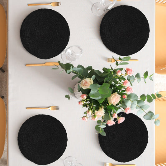 Decorated on a table, the Black Jute Placemat, a set of 2 or 4 round table mats you can buy online at Sukham Home, a sustainable furniture, kitchen & dining and home decor store in Kolkata, India
