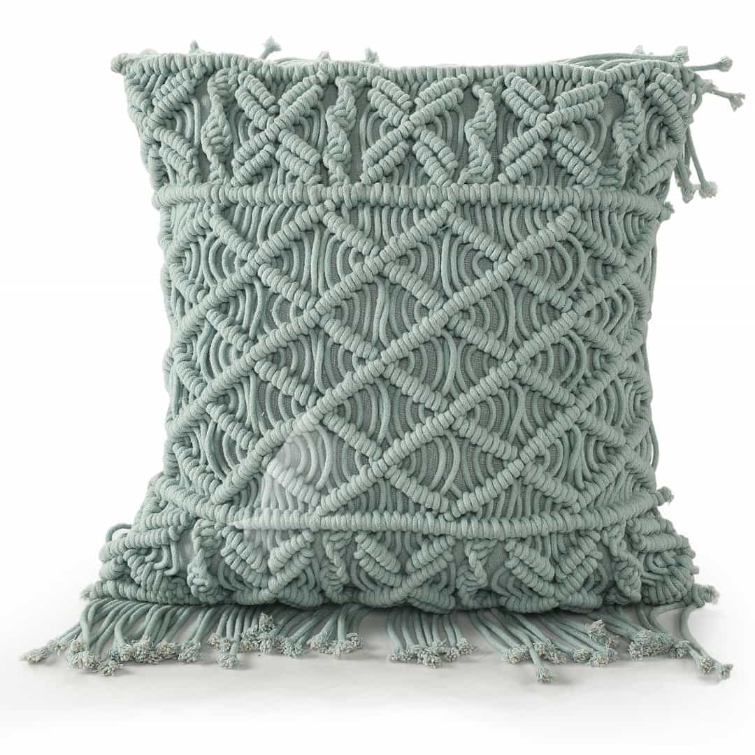 Against a white background, the Sky Blue Macrame Cushion, a square accent pillow you can buy online at Sukham Home, a sustainable furniture, kitchen & dining and home decor store in Kolkata, India