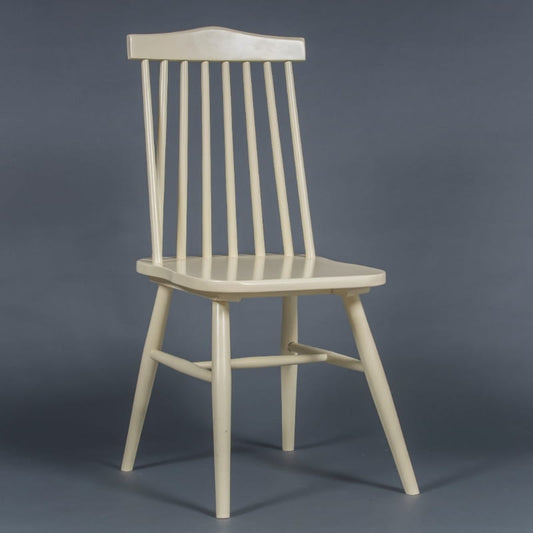 Against a grey background, the Oak Snow White String Chair, a solid wood Windsor dining seat you can buy online at Sukham Home, a sustainable furniture and home decor store in Kolkata, India
