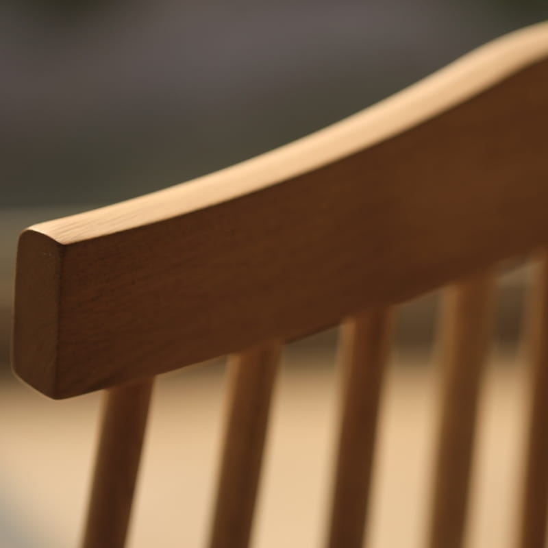 Top of the back of the Oak Natural String Chair, a solid wood Windsor dining seat you can buy online at Sukham Home, a sustainable furniture and home decor store in Kolkata, India