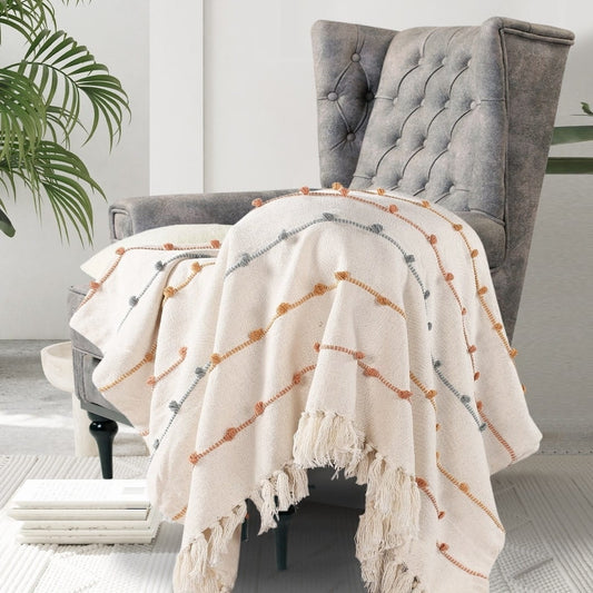 Placed on a chair, the Multi-Striped Cotton Throw, a white colourful striped throw you can buy online at Sukham Home, a sustainable furniture, kitchen & dining and home decor store in Kolkata, India