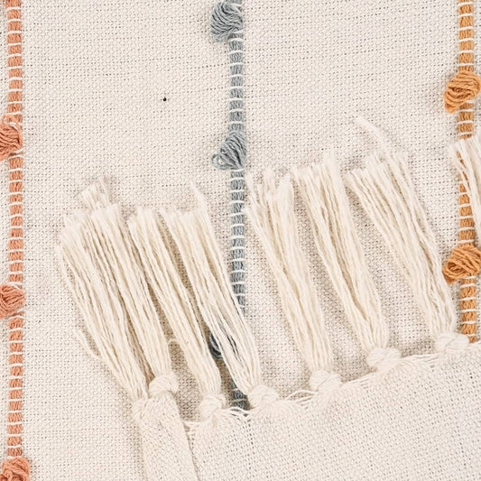Close up of the white tassels on the Multi-Striped Cotton Throw, a white colourful striped throw you can buy online at Sukham Home, a sustainable furniture, kitchen & dining and home decor store in Kolkata, India