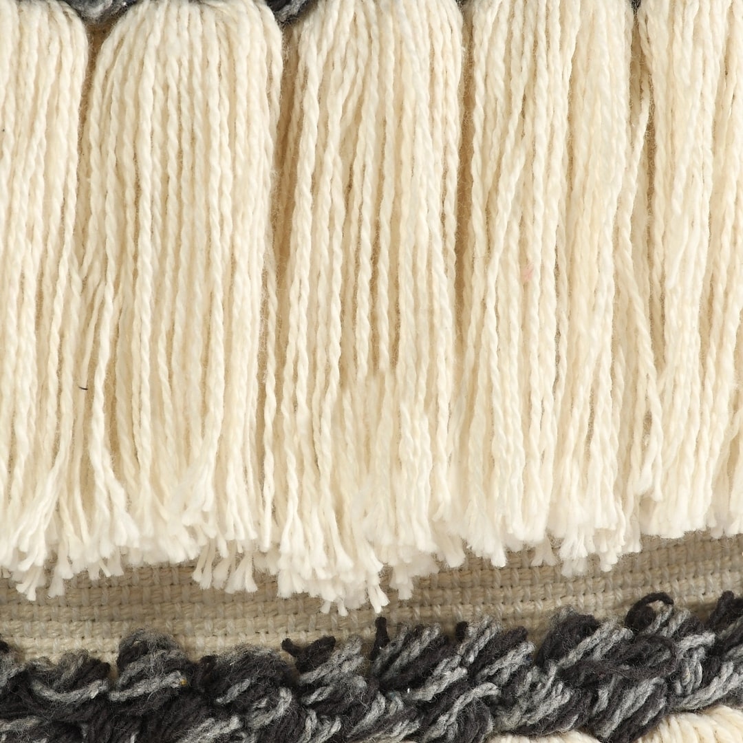 Close up of the white tassels on the Tasseled Laundry Basket, a white cotton laundry bag you can buy online at Sukham Home, a sustainable furniture, kitchen & dining and home decor store in Kolkata, India