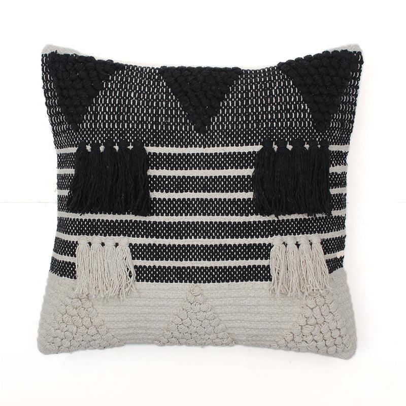 Against a white background, the Tassels & Triangles Cushion, a black and white tufted accent pillow you can buy online at Sukham Home, a sustainable furniture, kitchen & dining and home decor store in Kolkata, India