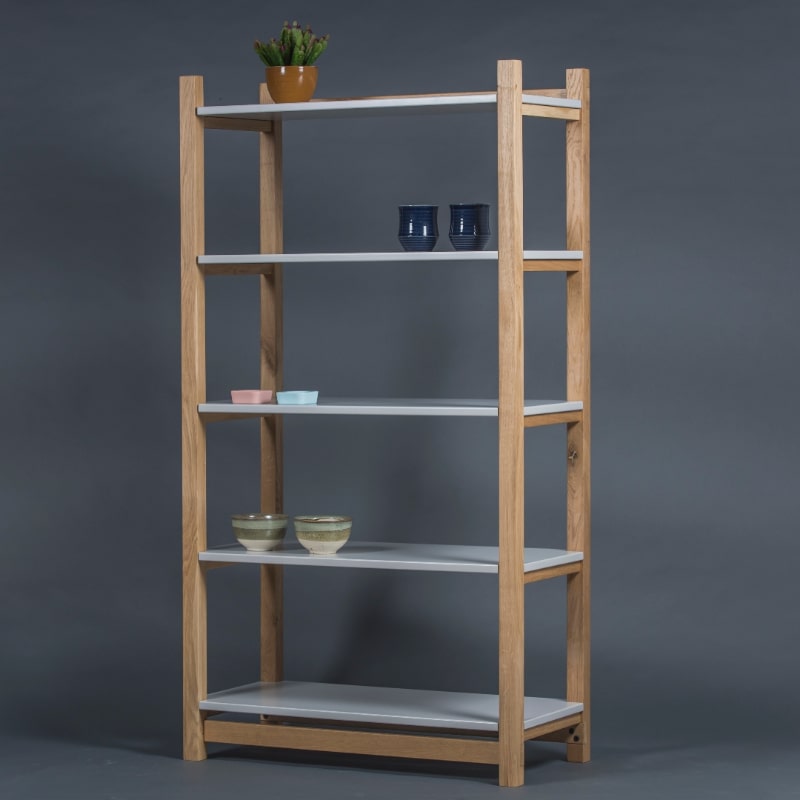 Placed against a grey background, the Tier Shelf, a multipurpose wooden open shelf storage solution and cabinet you can buy online at Sukham Home, a sustainable furniture, kitchen & dining and home decor store in Kolkata, India