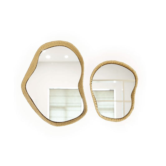 Against a white background, the Twist Mirror, a mirror frame made from golden grass that you can buy online at Sukham Home, a sustainable furniture, kitchen & dining and home decor store in Kolkata, India