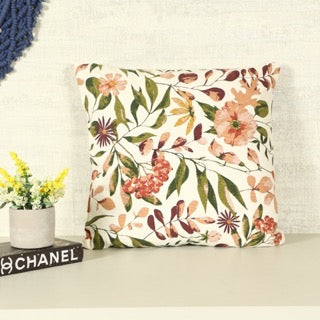 Placed on a grey shelf, the Vibrant Flora Cushion, a square printed floral accent pillow available at Sukham Home, a sustainable furniture, kitchen & dining and home decor store in Kolkata, India