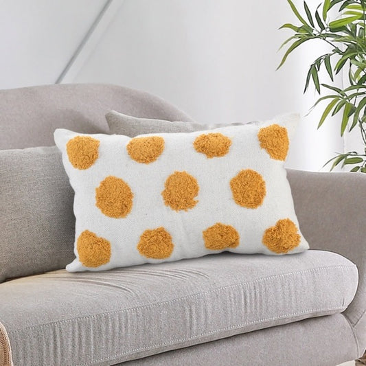 On a sofa, the White Lumbar Cushion with Tufted Yellow Circles, a rectangle ivory and mustard polka-dot accent pillow available at Sukham Home, a sustainable furniture, kitchen & dining and home decor store in Kolkata, India