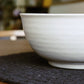 Close up of the ribbed texture of the Ivory Ganga Serving Bowl, a white and 24-karat gold ceramic serving big bowl you can buy online at Sukham Home, a sustainable furniture, gardening and home decor store in Kolkata, India