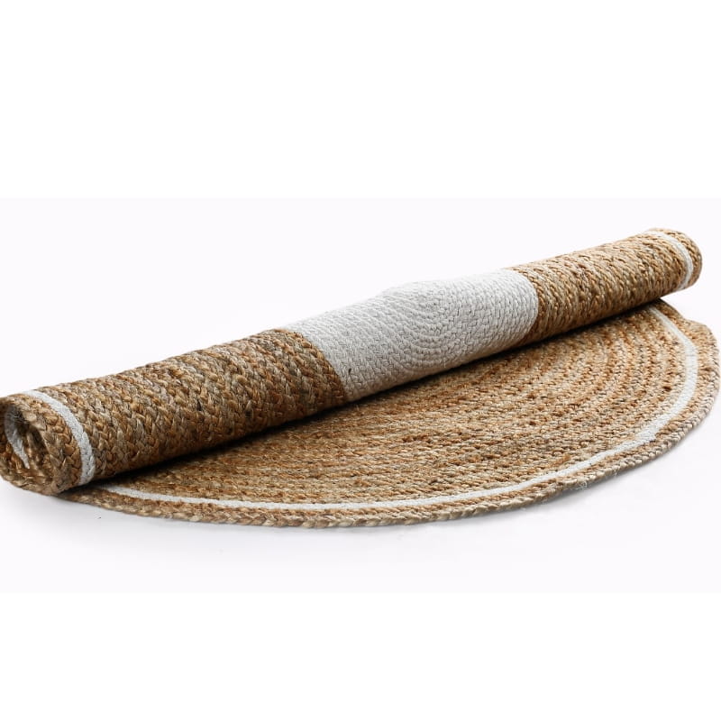 Rolled up, the Braided Round Jute Rug with White Border, a circular jute and white cotton carpet you can buy online at Sukham Home, a sustainable furniture, kitchen & dining and home decor store in Kolkata, India