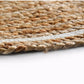 Close up of the finishing on the ends of the Braided Round Jute Rug with White Border, a circular jute and white cotton carpet you can buy online at Sukham Home, a sustainable furniture, kitchen & dining and home decor store in Kolkata, India