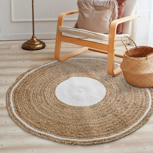 Below an armchairs, the Braided Round Jute Rug with White Border, a circular jute and white cotton carpet you can buy online at Sukham Home, a sustainable furniture, kitchen & dining and home decor store in Kolkata, India