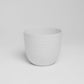 A single white Verona, a round colourful indoor planter made from plastic that you can buy online at Sukham Home, a sustainable furniture, gardening and home decor store in Kolkata, India