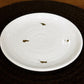 Side view of the Ivory Ganga Quarter Plate, a white and 24-karat gold ceramic small plate you can buy online at Sukham Home, a sustainable furniture, gardening and home decor store in Kolkata, India