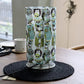 Placed on a table without the light on, Wise Owl, a cloth canvas table lamp with many quirky owl designs you can buy online at Sukham Home, a sustainable furniture, kitchen & dining and home decor store in Kolkata, India