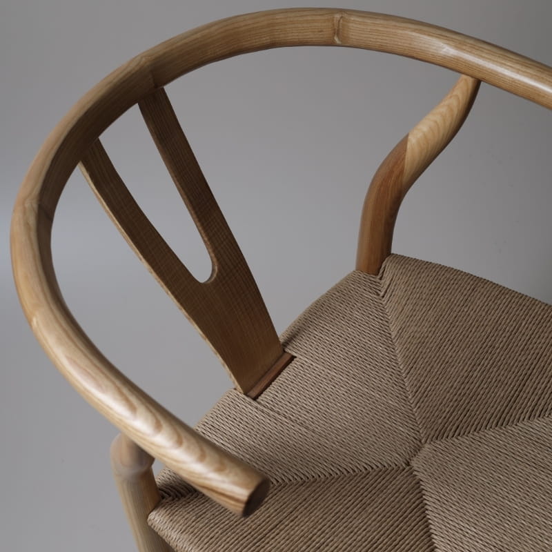 Close up of the rattan seat on the Wishbone Chair, a solid wood rattan dining seat you can buy online at Sukham Home, a sustainable furniture and home decor store in Kolkata, India