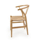 Against a white background, side view of the Oak Natural Wishbone Chair, a solid wood rattan dining seat you can buy online at Sukham Home, a sustainable furniture and home decor store in Kolkata, India