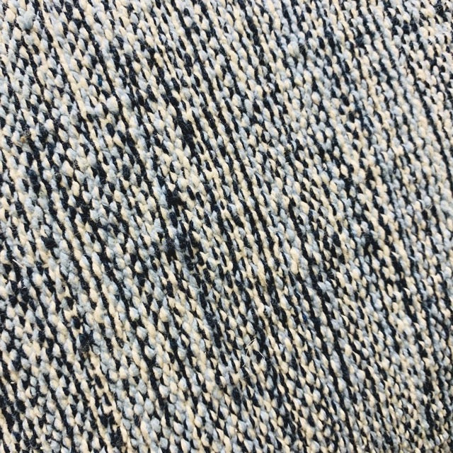 Close up of weaving of Woven Melange Cushion, a plain blue accent pillow available at Sukham Home, a sustainable furniture, kitchen & dining and home decor store in Kolkata, India