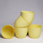 Five pieces of yellow Verona, a round colourful indoor planter made from plastic that you can buy online at Sukham Home, a sustainable furniture, gardening and home decor store in Kolkata, India