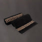 Two embroidered bath towels from the Black Silly-Cuddly, a set of 8 black & gold towels you can buy online at Sukham Home, a sustainable furniture, kitchen & dining and home decor store in Kolkata, India