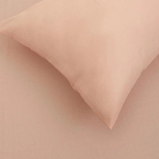 Close up of the texture and fabric of the Pink Solid Bedsheet, a pale pink king and queen size cotton bedsheet you can buy online at Sukham Home, a sustainable furniture, gardening and home decor store in Kolkata, India