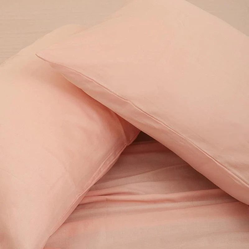 Both pillowcases of the Pink Solid Bedsheet, a pale pink king and queen size cotton bedsheet you can buy online at Sukham Home, a sustainable furniture, gardening and home decor store in Kolkata, India