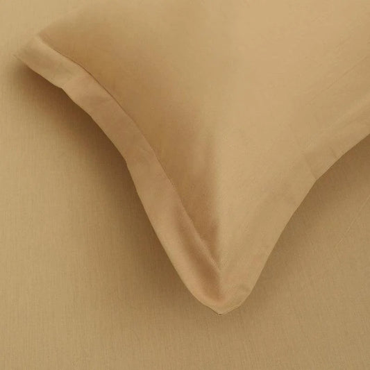 Close up of the fabric and texture of the Mustard Solid Bedsheet, a yellow ochre king and queen size cotton bedsheet you can buy online at Sukham Home, a sustainable furniture, gardening and home decor store in Kolkata, India
