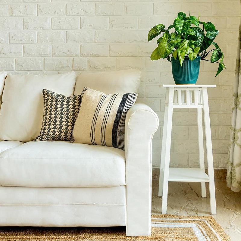 On a white sofa, the Linear Beige Cushion, a linen black and white geometric printed accent pillow you can buy online at Sukham Home, a sustainable furniture, kitchen & dining and home decor store in Kolkata, India